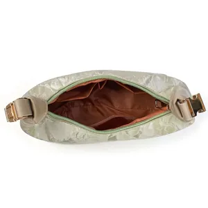 Interior view of the light green handbag showing organized pockets and brown lining