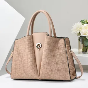 Detail of nude beige handbag showing woven texture, leather stitching and gold metal lock