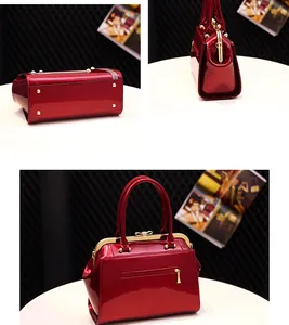 Detail view of burgundy glossy patent leather tote with metal feet and golden hardware