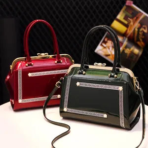 Glossy patent leather frame handbags in burgundy and dark green with vintage bow lock