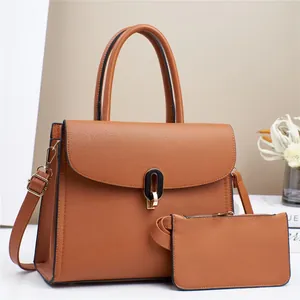 Close-up of caramel lychee grain leather tote and matching pouch with gold clasp