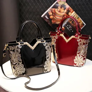 Elegant glossy leather handbags in black and burgundy with floral embroidery and sequins