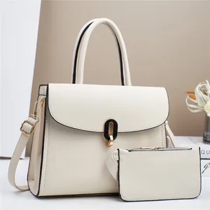 Detailed view of beige pebble leather tote bag set with metal clasp and inner pouch