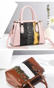 Detail of glossy patchwork handbags with animal texture in pink and brown tones