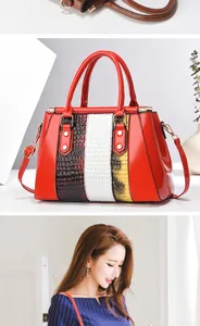 Detail view of red patent leather handbag with embossed faux crocodile pattern patchwork