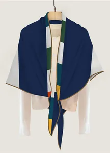 Detailed view of deep blue geometric color-block triangle scarf with brown hem details