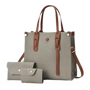 Three-piece beige canvas tote bag set with brown faux leather straps and small pouches