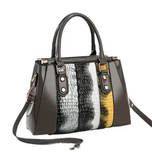 Glossy patent leather handbag with snakeskin patchwork and adjustable shoulder strap