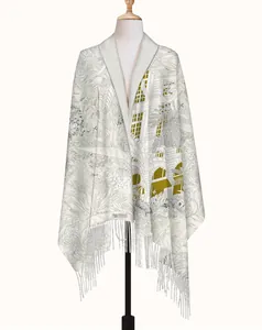 Close-up of cream floral cashmere shawl with elegant fringe and tropical patterns
