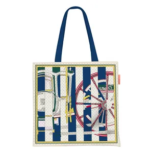 Detailed close-up of a white canvas tote bag with blue horse carriage wheel patterns