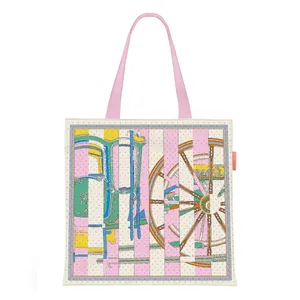 Large canvas tote bag featuring vintage carriage wheel prints and pink handles