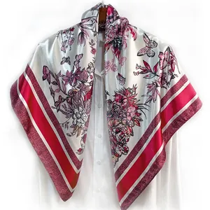 Detail of silk-satin scarf with floral and butterfly prints draped on a white shirt
