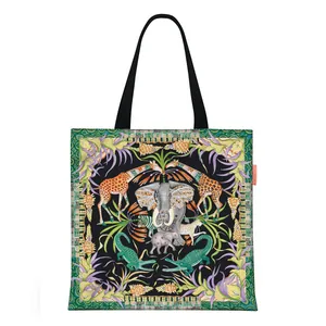 Artistic tropical animal print on black canvas tote bag showing elephant and giraffes