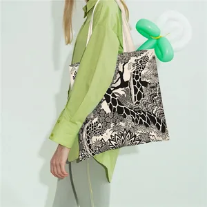 Detail of artistic giraffe and tropical plant print on large canvas tote bag
