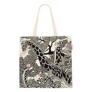 Detail view of artistic giraffe and tropical plant print on durable canvas tote bag