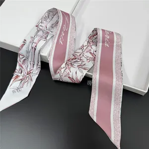 Close-up of a floral silk scarf with Paris script and polyester wash tag details