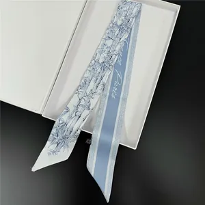Blue and white silk twilly scarf with bamboo floral prints and a white gift box