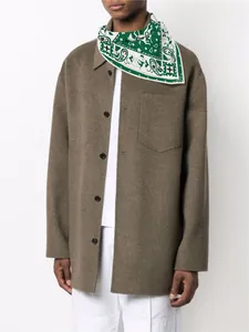Detail of silk square scarf in forest green with paisley pattern worn on model