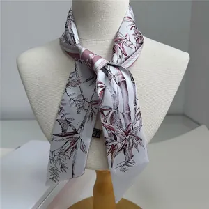 Floral print narrow twilly scarf with bamboo pattern tied on a mannequin neck