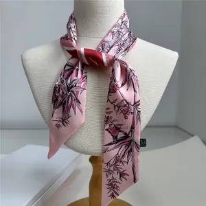 Elegant pink floral bamboo silk scarf tied on a model for versatile accessory styling