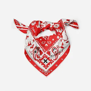 Detail of silk square scarf featuring paisley prints and intricate animal patterns