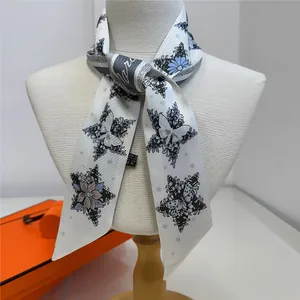Star and butterfly print faux silk twilly scarf displayed on a white mannequin
