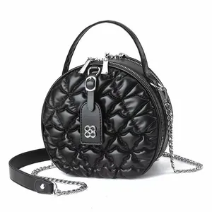 Quilted round black puffer shoulder bag with silver chain strap and floral metal logo