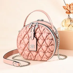 Pink heart-quilted round shoulder bag with top handle and golden chain strap