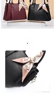 Detail of burgundy and black tote bags with stylish printed silk scarf on handles