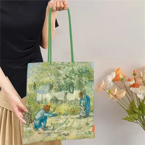 Détail du sac cabas imprimé Van Gogh avec poignées vertes porté par un mannequin