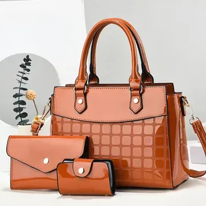Three-piece set of caramel orange patent leather handbags with stylish quilted texture