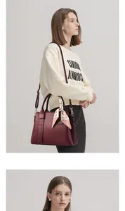 Close-up of burgundy lychee leather handbag featuring decorative printed silk scarf on handle