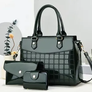 Dark green 3-piece tote bag set in patent leather with textured patterns and gold hardware