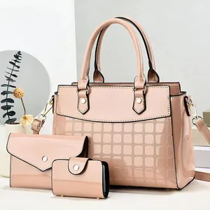 Three-piece light pink patent leather handbag set with tote, wallet, and card holder