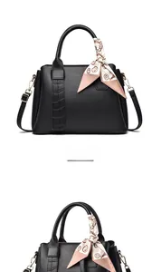 Close-up of black litchi grain handbag with crocodile pattern detail and floral silk scarf