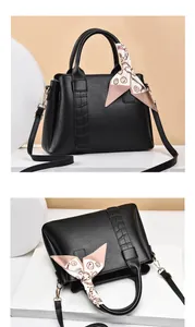 Detailed views of black lychee leather handbag with crocodile trim and decorative silk scarf