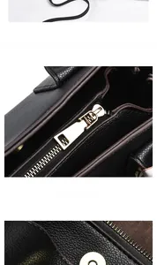 Close-up of golden zipper puller and pebbled leather texture on black tote bag