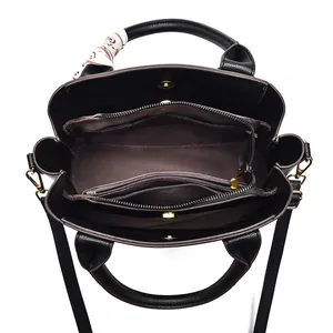 Large black leather handbag with three compartments and decorative scarf detail