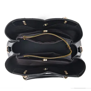 Vista dall'alto della borsa tote in pelle nera con scomparti multipli e cerniere d'oro