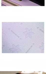 Detail of purple PU leather handbag featuring lychee texture and floral embossed patterns