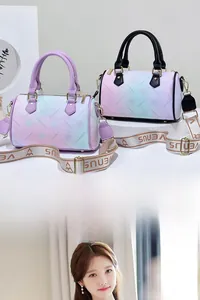 Detail of gradient floral Boston bag with wide detachable shoulder strap and gold hardware