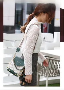 Detail of green and white rhombic pattern crossbody bag with a cute bear charm accessory