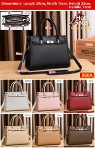 Detail view of large solid color handbag with multiple compartments and dimensions info