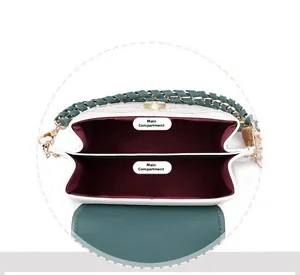 Detail view of the two main compartments and burgundy lining of this crossbody bag