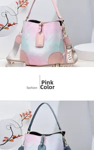 Close-up of pink gradient bucket bag with floral patterns and stylish wide shoulder strap