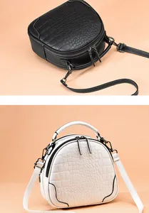 Detailed view of dual-zip crossbody bags in black and white crocodile skin texture
