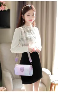 Détail du sac Boston violet clair avec motifs floraux et large bandoulière tissée logotée