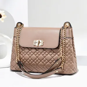 Detailed close-up of the quilted leather texture and rhinestone-studded golden lock