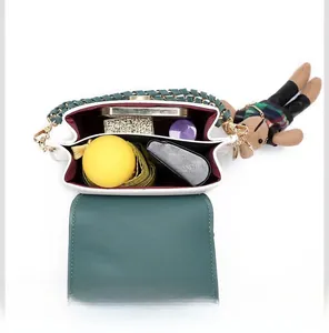 Top view of compact crossbody bag showing interior space for phone, umbrella and accessories