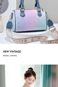 Detail of gradient Boston bag with floral embossing and wide branded shoulder strap